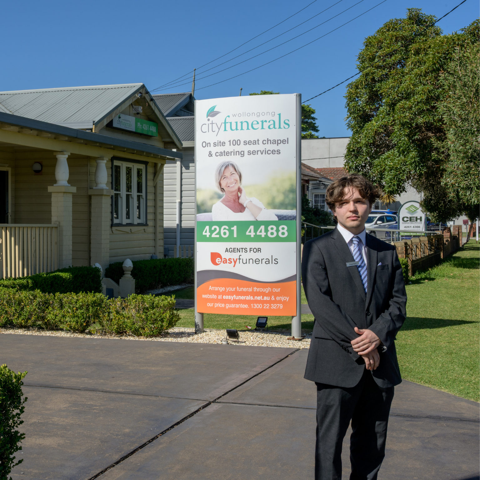 Wollongong City Funerals chapel exterior with a staff member standing beside the entrance