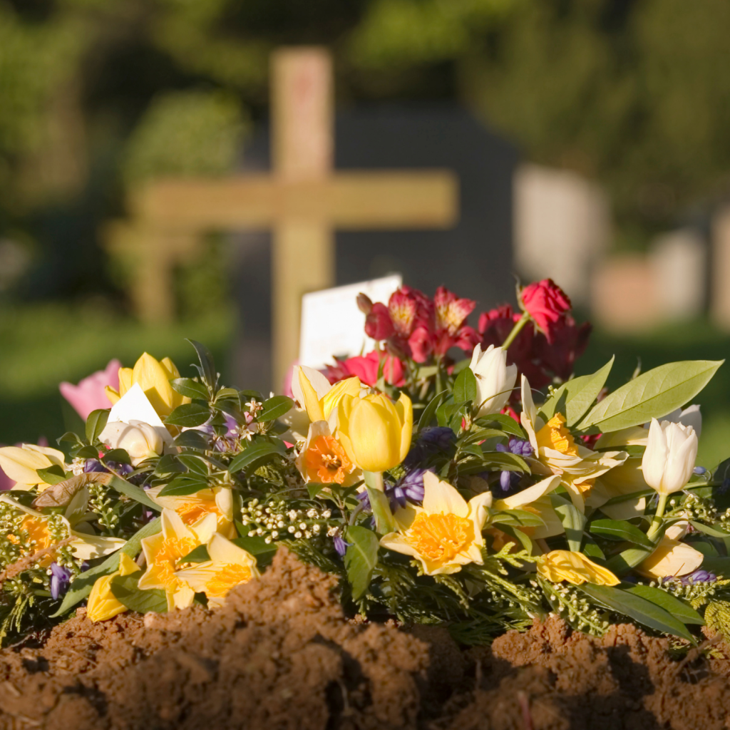 Funeral burial with flowers at a graveside
