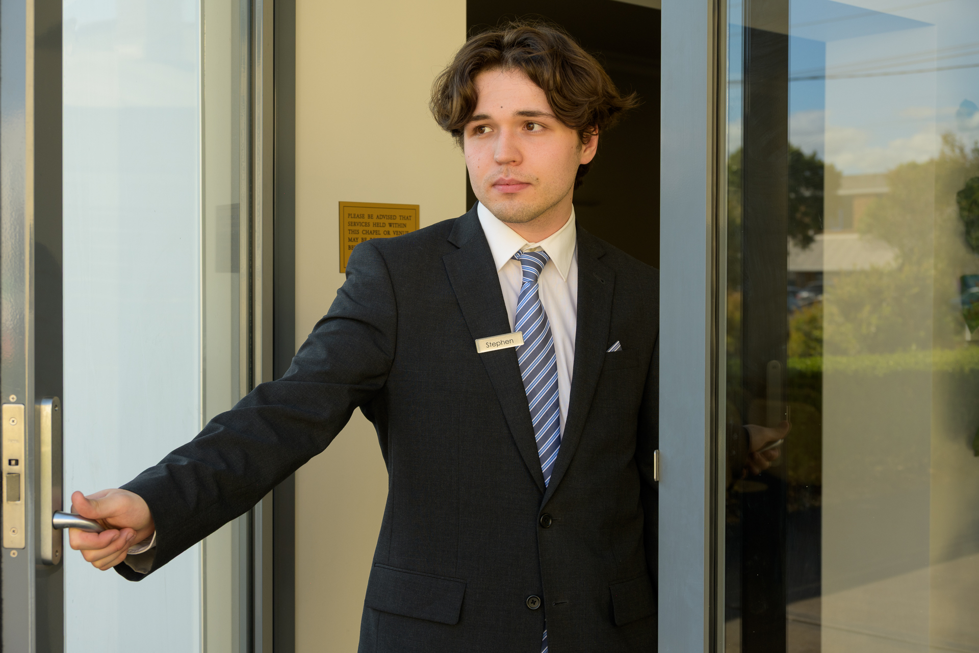Funeral director welcoming visitors at Wollongong City Funerals