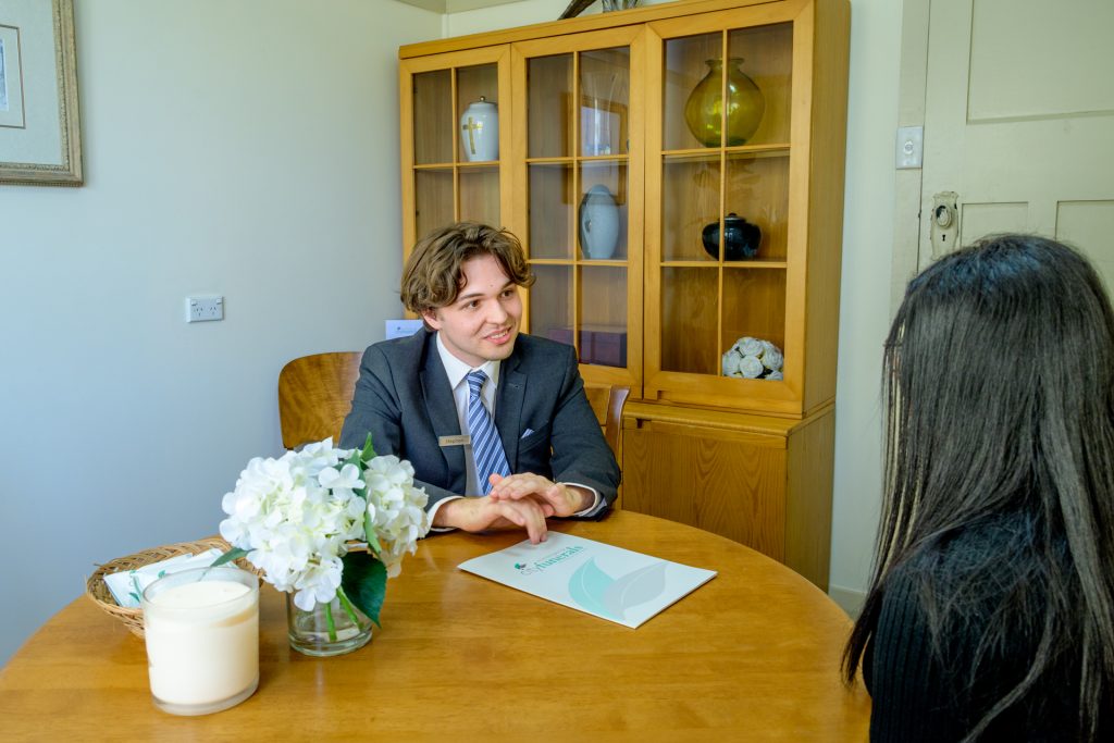 Funeral director discussing funeral arrangements with a client in Wollongong